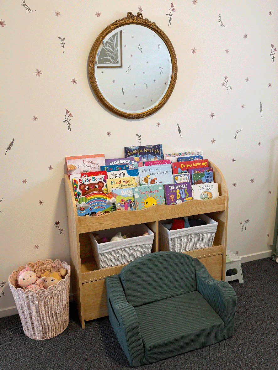 Children's reading area with books, chair and storage baskets