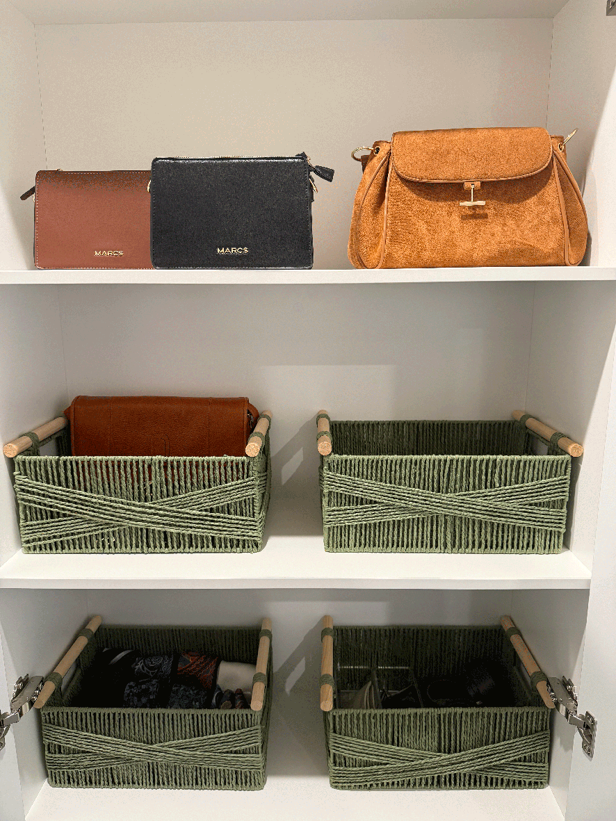 Wardrobe shelves organised with woven baskets and handbags