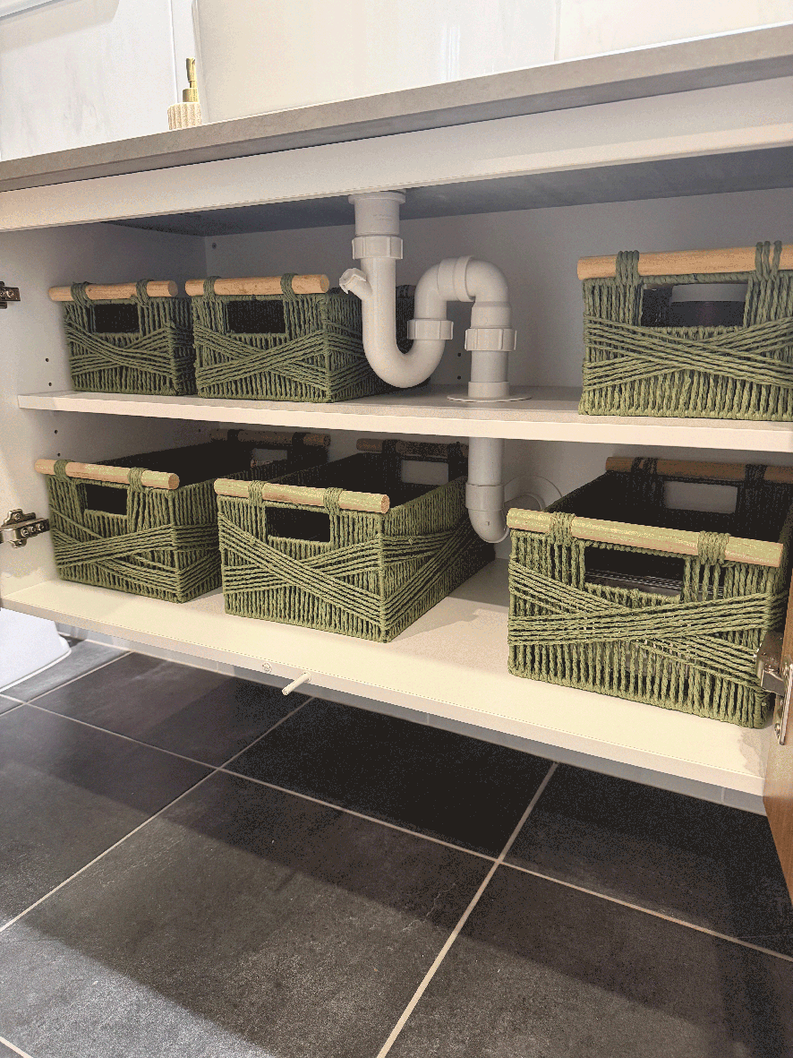 Bathroom cabinet organised with woven baskets